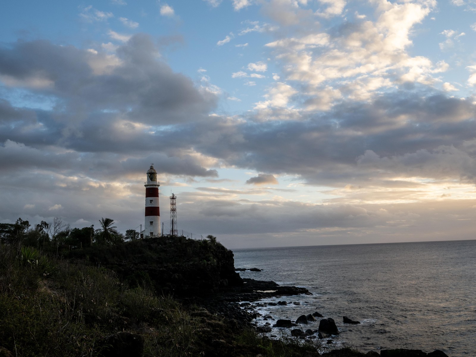 Pointe aux Caves lighthouse above the rocky Albion coast. 31 August.