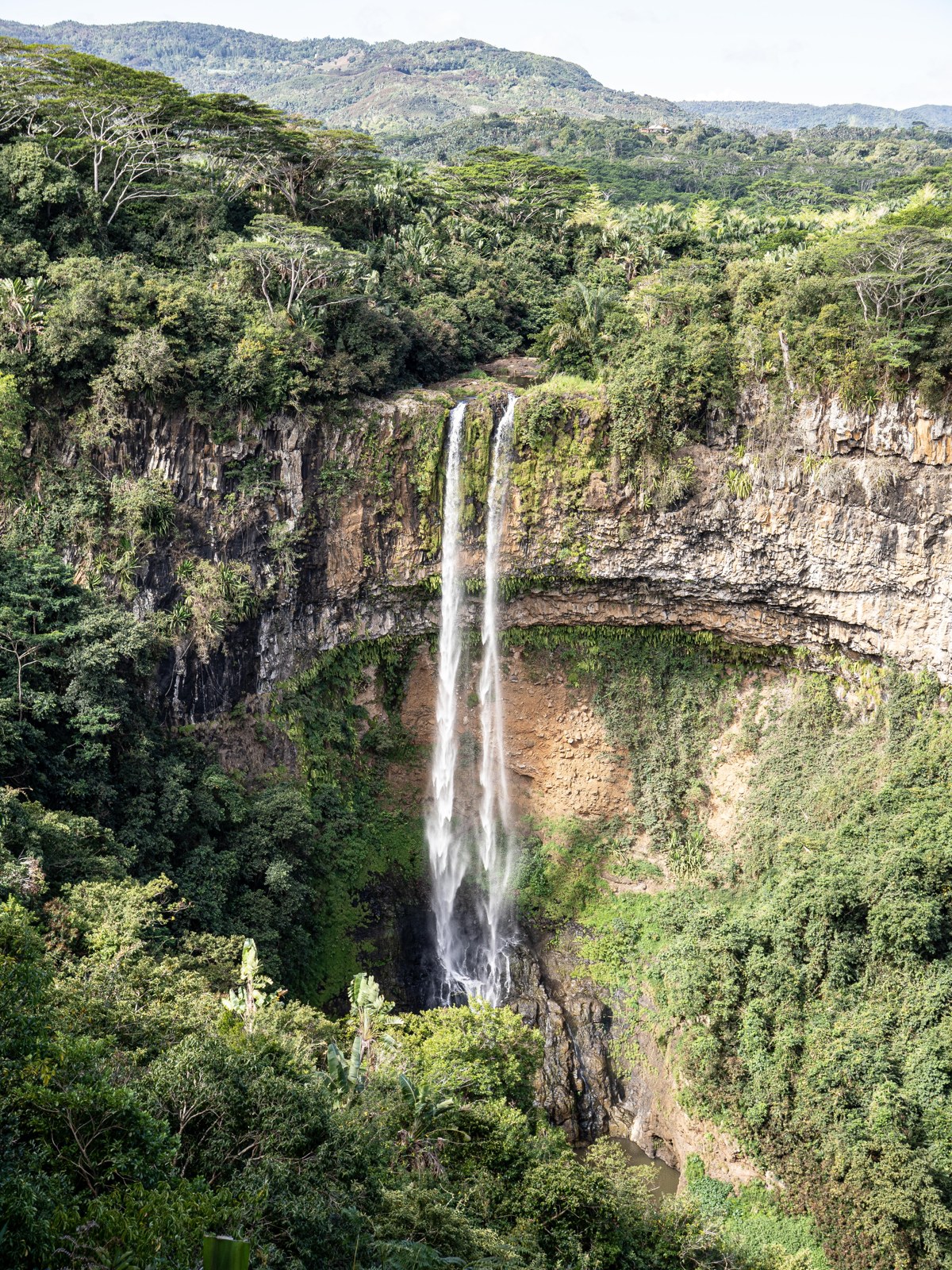 Chamarel Falls surrounded by green volcanic cliffs in Mauritius